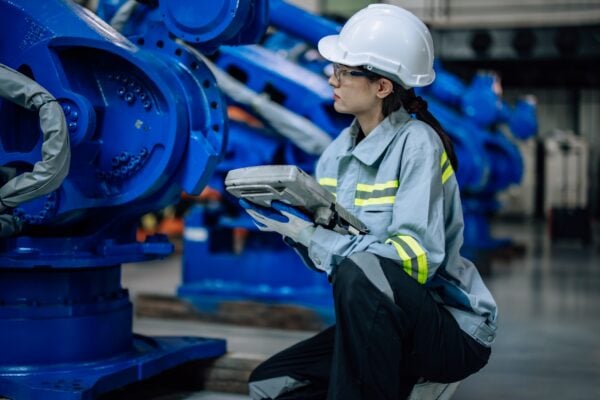 Woman doing quality check on machinery