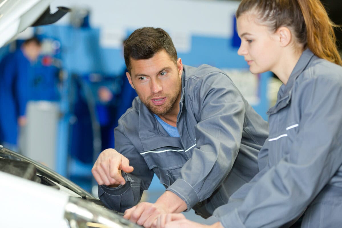 Mechanics fixing the engine of a van